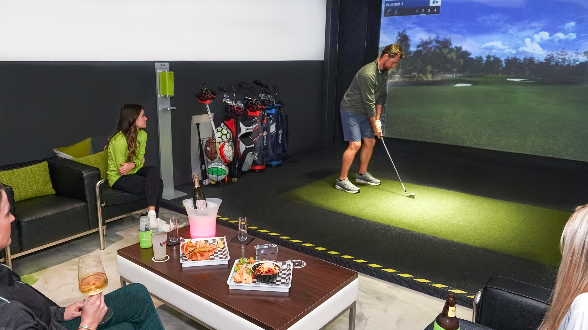 Man playing on an indoor golf simulator