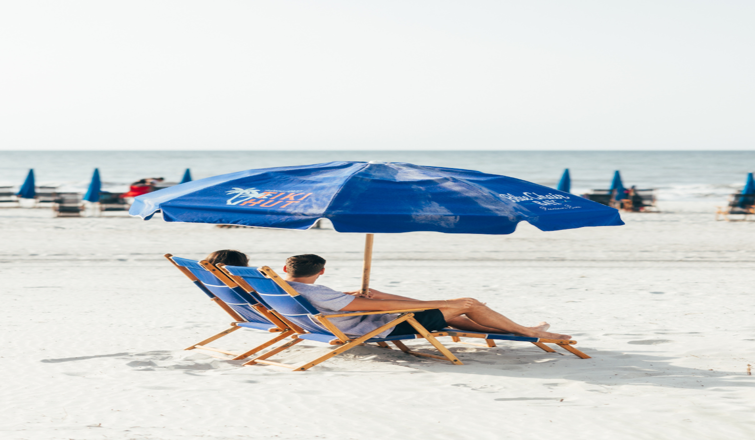 A couple sitting in beach chairs on the beach